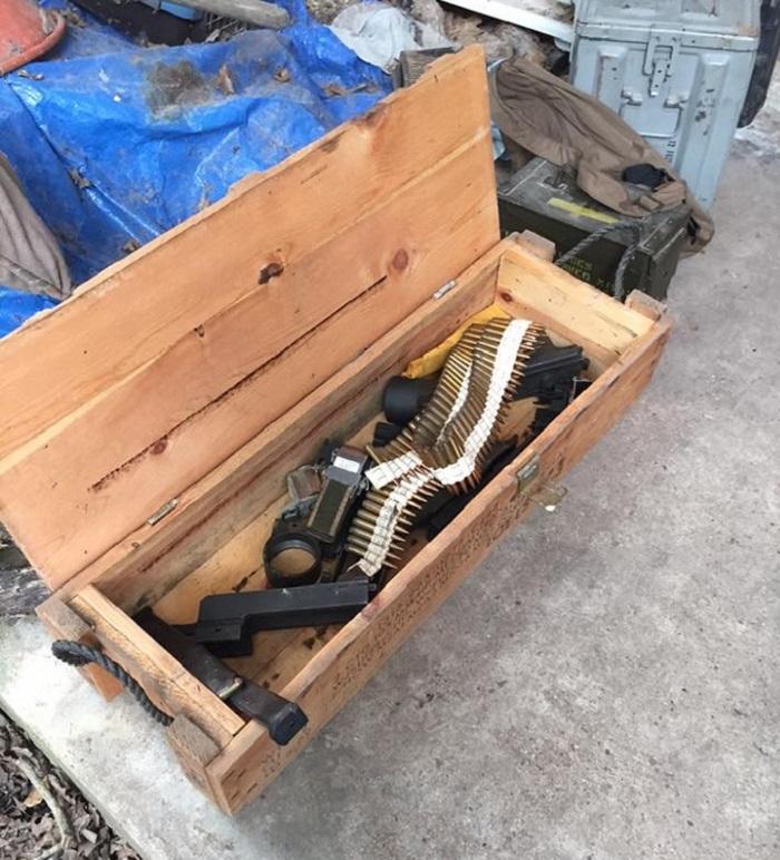 Firearms and ammunition in a wooden crate