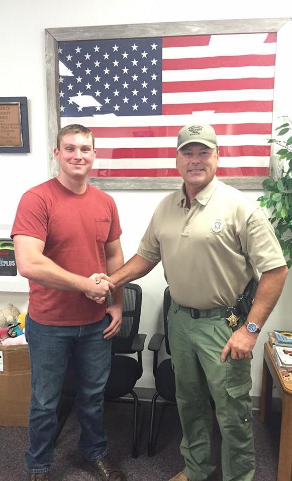 Jaron Bullock shakes hands with Sheriff Tanner