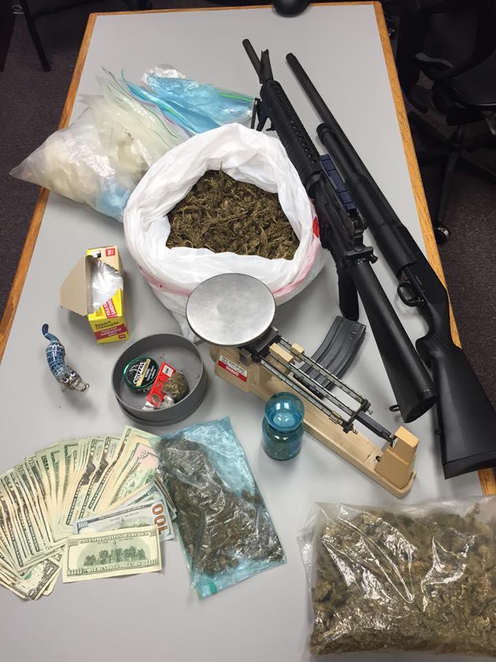 4 pounds of marijuana, guns, baggies, scales and cash