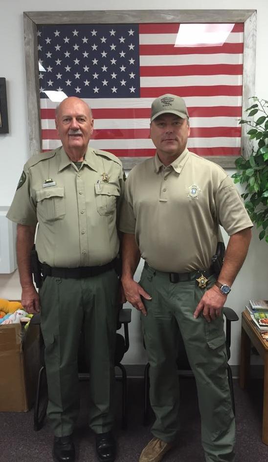 Captain Jimmy Johnson stands next to Sheriff Tanner 