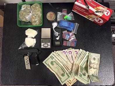 56 grams of cocaine in crack form, ecstasy, marijuana, pistol, cash, digital scales and paraphernalia were seized