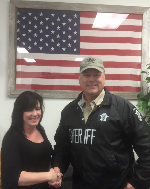 Sheriff shaking Amy Plant's hand