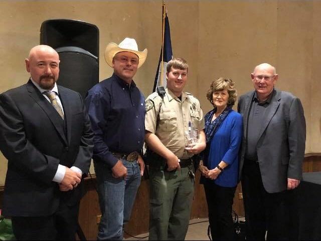 Sheriff Tanner and Deputy Ryan Gantt stand with others after the award ceremony