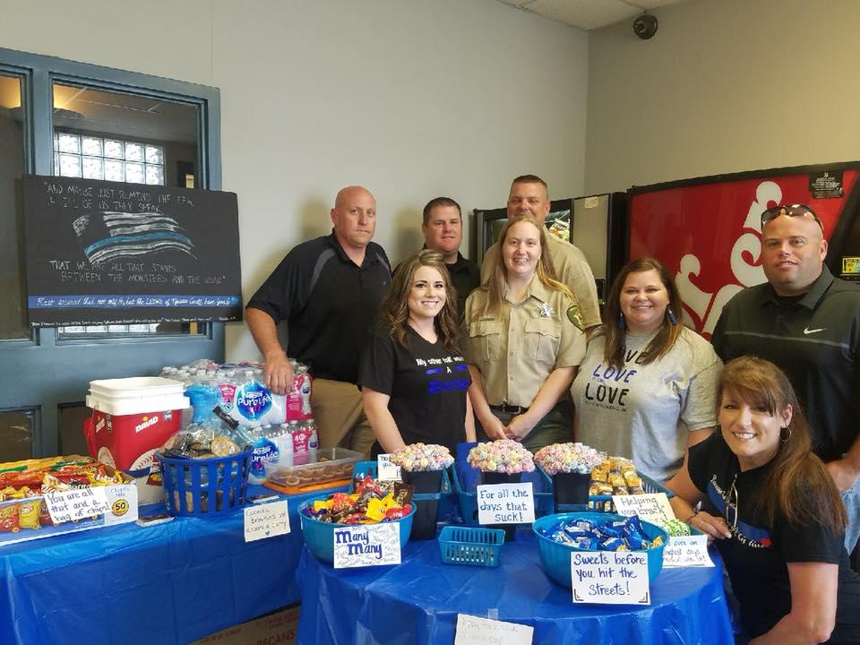 NCSO gathers around the snacks and gifts from the kids