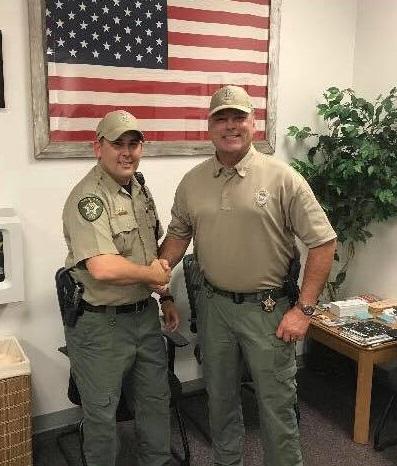 Deputy Nick Wickliffe shakes Sheriff Tanner's hand